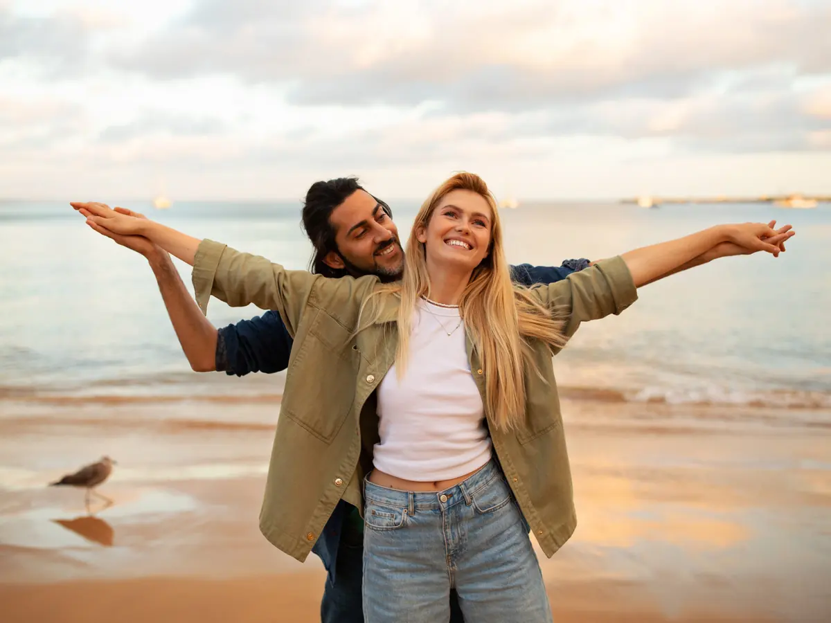Couple outdoors at the coast, relaxed and energetic